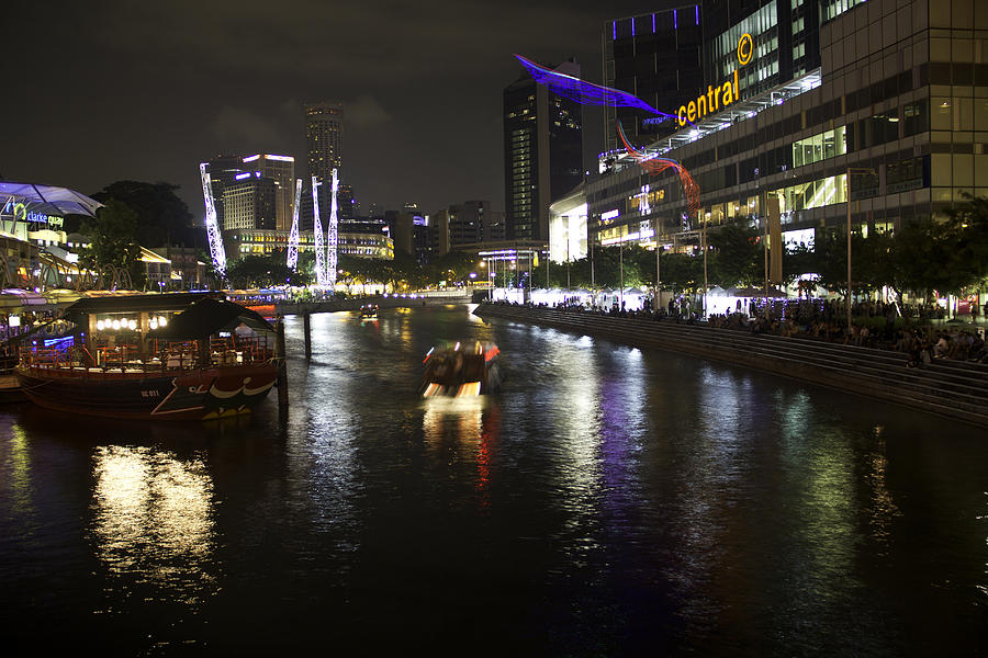 Lamp Photograph - Boat making its way down river at Clarke Quay in Singapore by Ashish Agarwal