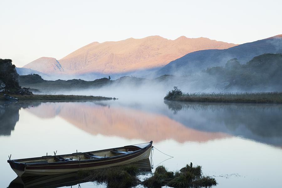 Boat On A Tranquil Lake Killarney Photograph by Peter Zoeller