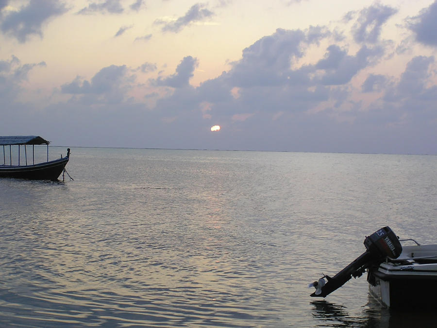 Boats coming to a rest for the day at sunset in the Lakshadweep Islands Photograph by Ashish Agarwal