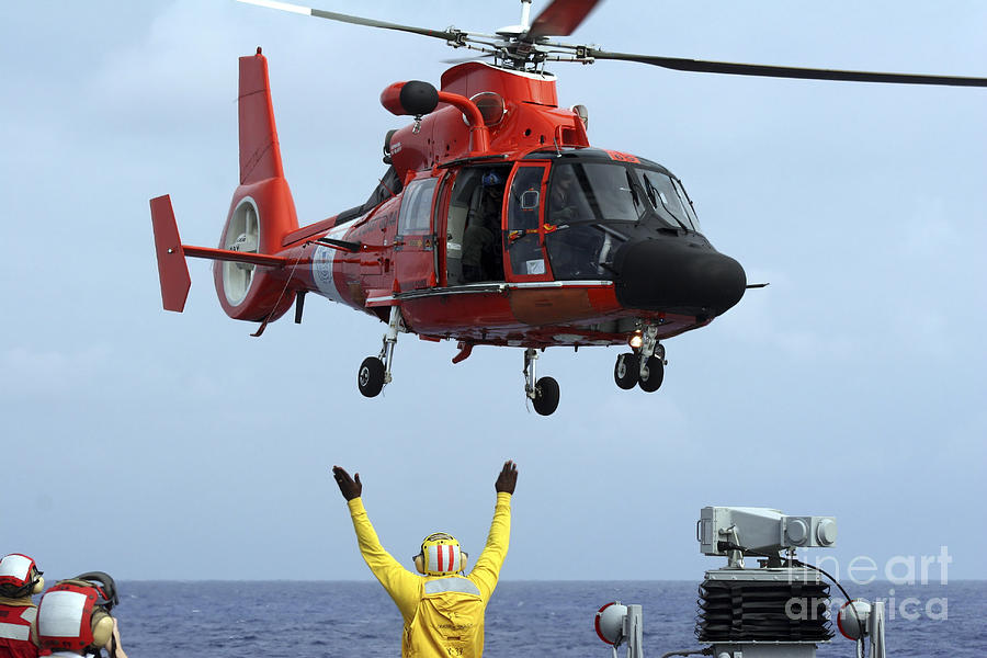 Boatswain Mate Directs A Hh-65a Dolphin Photograph by Stocktrek Images