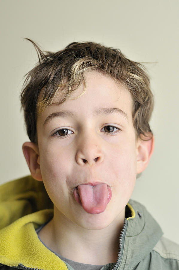Boy pokes his tongue out Photograph by Matthias Hauser