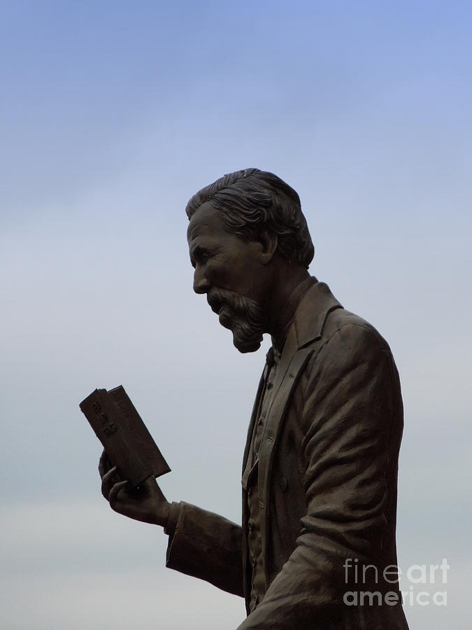 Bronze Statue of Man Reading sky background Photograph by Renee Trenholm