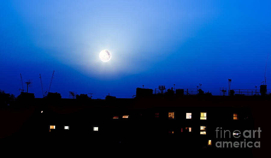 Buildings silhouette and moon  Photograph by Simon Bratt