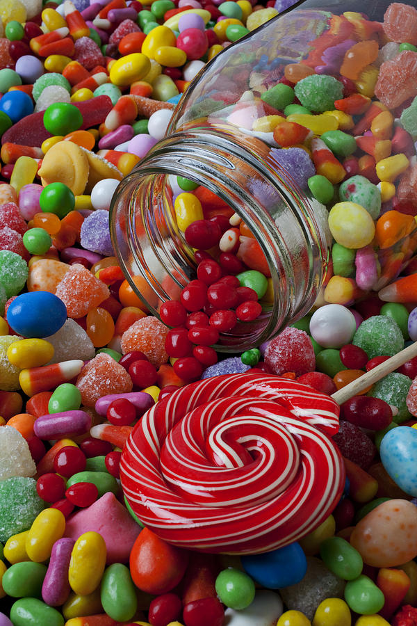 Candy jar spilling candy Photograph by Garry Gay
