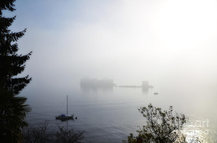 Castle on a foggy lake Photograph by Mats Silvan