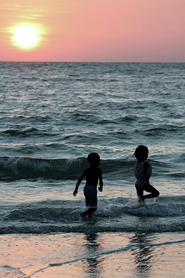 Children Playing at Sunset Photograph by Jeanne Juhos