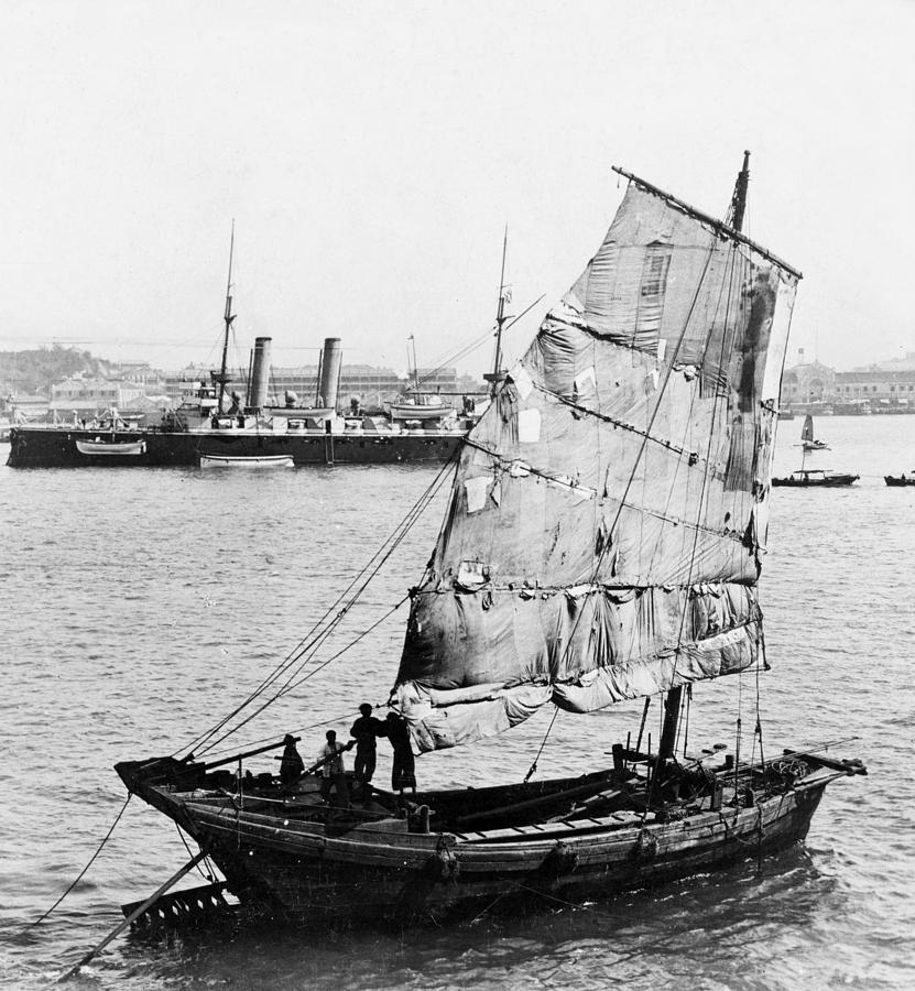 Chinese Junk Ship and British Battleship in Hong Kong - c 1902  Photograph by International  Images