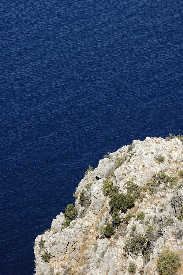 Cliff and deep blue water Photograph by Matthias Hauser