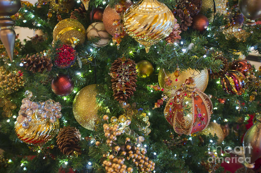 Christmas Photograph - Closeup of Christmas Ornaments hanging at artificial Christmas tree by Andre Babiak