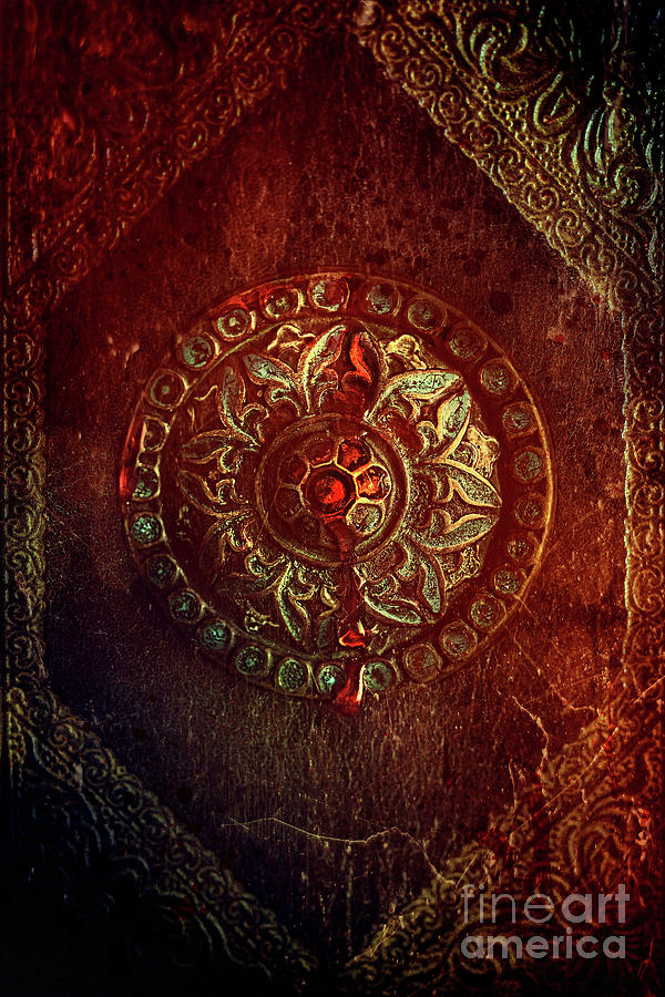 Closeup of old artifact on antique book background Photograph by Sandra Cunningham