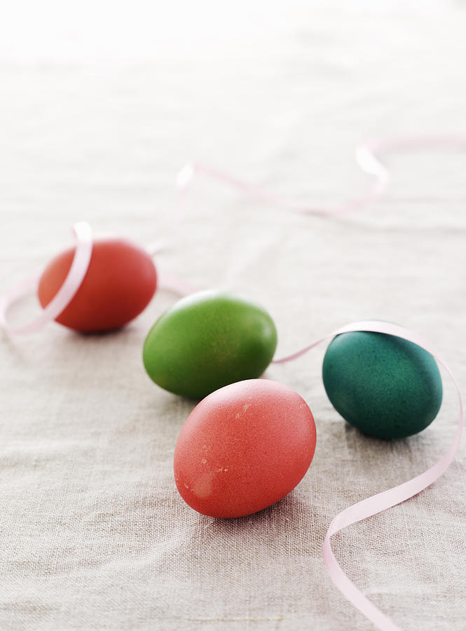 Still Life Photograph - Colorful Easter Eggs With Ribbon by Cultura/BRETT STEVENS