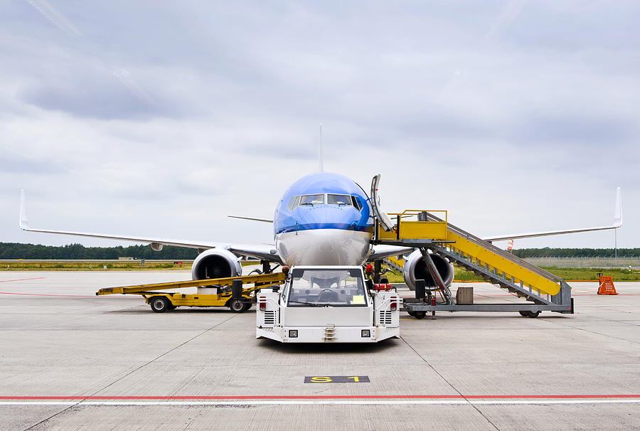 Commercial Airliner Parked At An Photograph by Corepics - Fine Art America