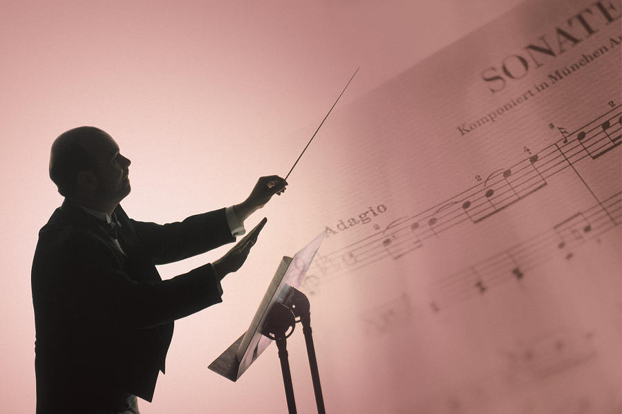 Conductor With Sheet Music Photograph by Comstock
