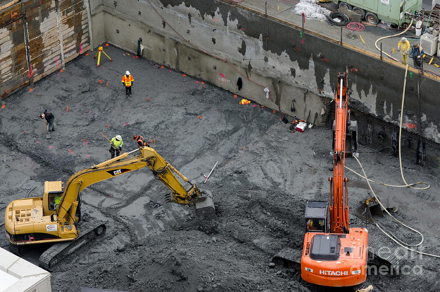 Seattle Photograph - CONSTRUCTION SITE diggers and workmen in the foundation pit of a new building Seattle by Andy Smy