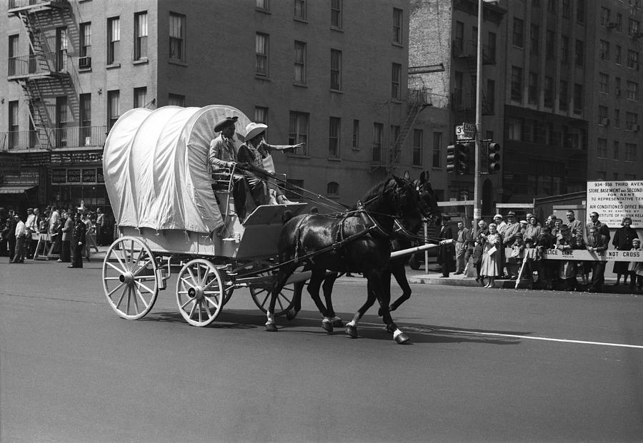 Covered Wagon On Street During Parade Photograph by George Marks