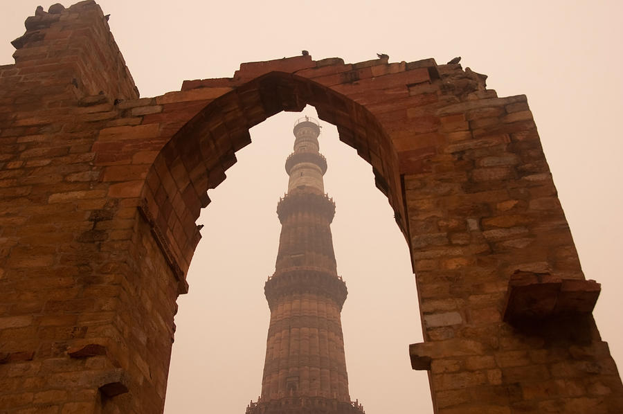 Cross section of the Qutub Minar framed within an archway in foggy weather Photograph by Ashish Agarwal