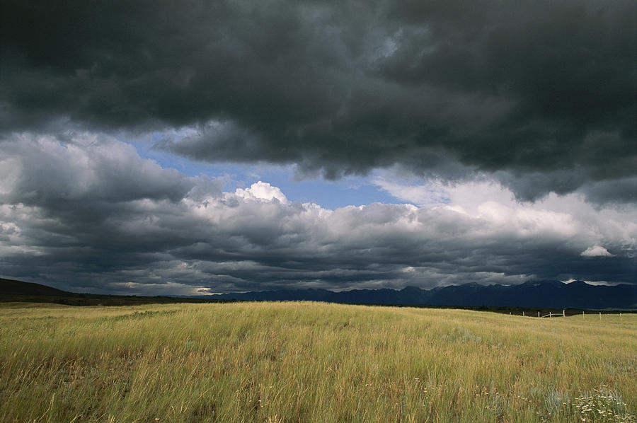 Dark Clouds Gather Over A Prairie Photograph by Annie Griffiths