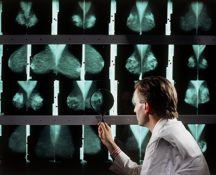 Doctor Examines Breast Mammograms On A Lightbox Photograph by Geoff ...