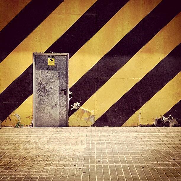 Barcelona Photograph - Door and yellow-black stripes by Jordi Codina
