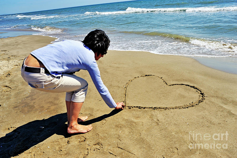 Valentines Day Photograph - Drawing heartshape in sand by Sami Sarkis