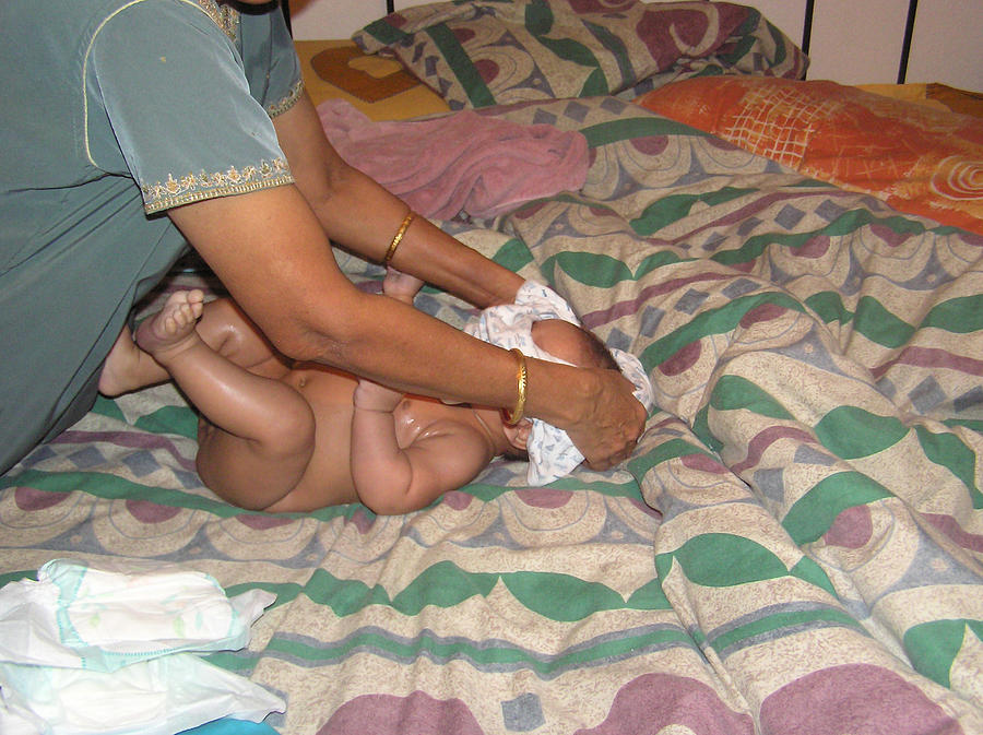 Dressing a baby after a bath Photograph by Ashish Agarwal