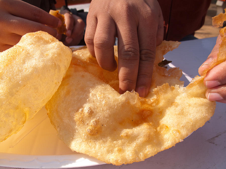 Eating by hand the Indian delicacy of Chole Bhature Photograph by Ashish Agarwal
