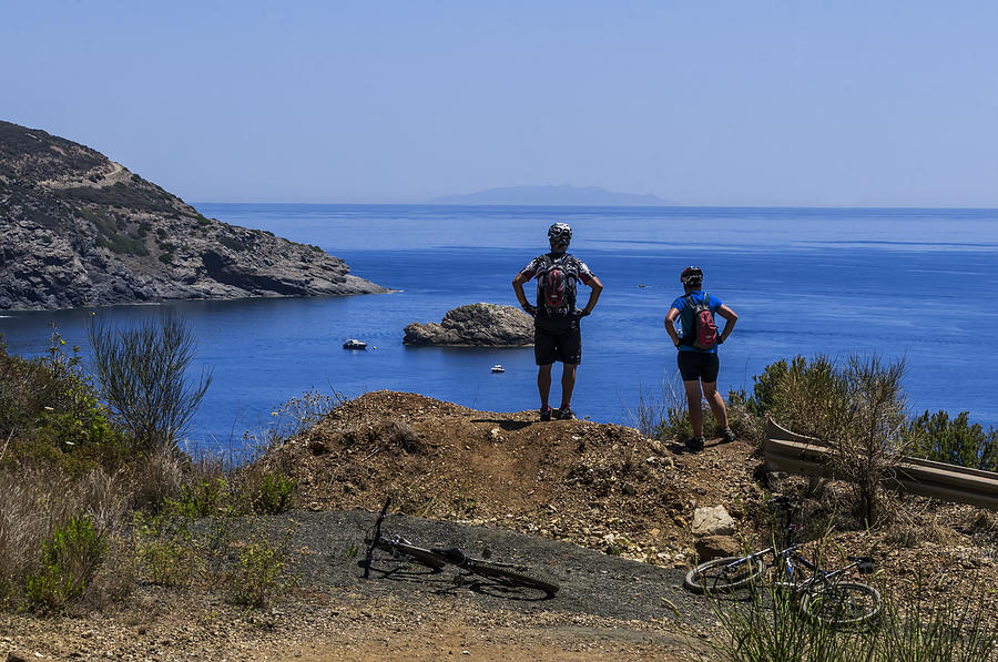 ELBA ISLAND - MTB Bikers looking the far away island - ph Enrico Pelos Photograph by Enrico Pelos