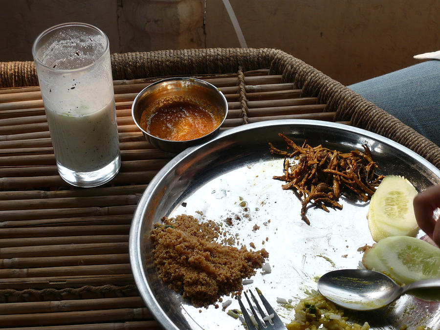 Enjoying a plate of Rajasthani food on a steel plate on a bamboo table Photograph by Ashish Agarwal