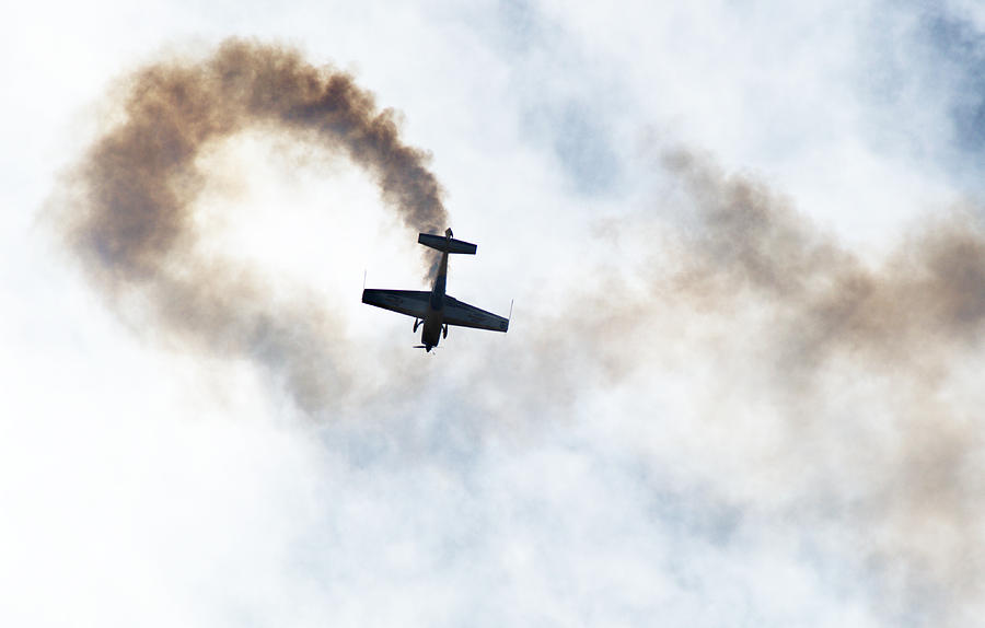 Extra 300 aerobatic plane and smoke trail Photograph by Chris Day