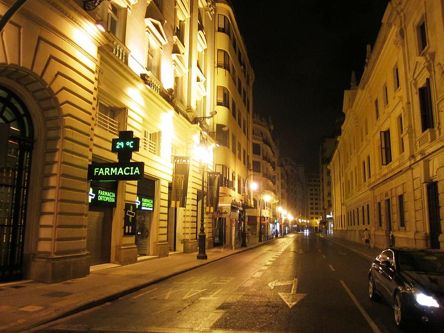 Farmacia Pharmacy on Local Street of Valencia with Lamp Posts At Night in Spain Photograph by John Shiron