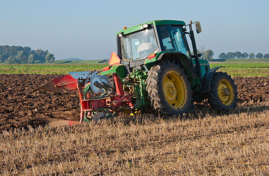 Farmer Plowing The Harvested Cornfield With A Two Furrow Plow by Ruud ...