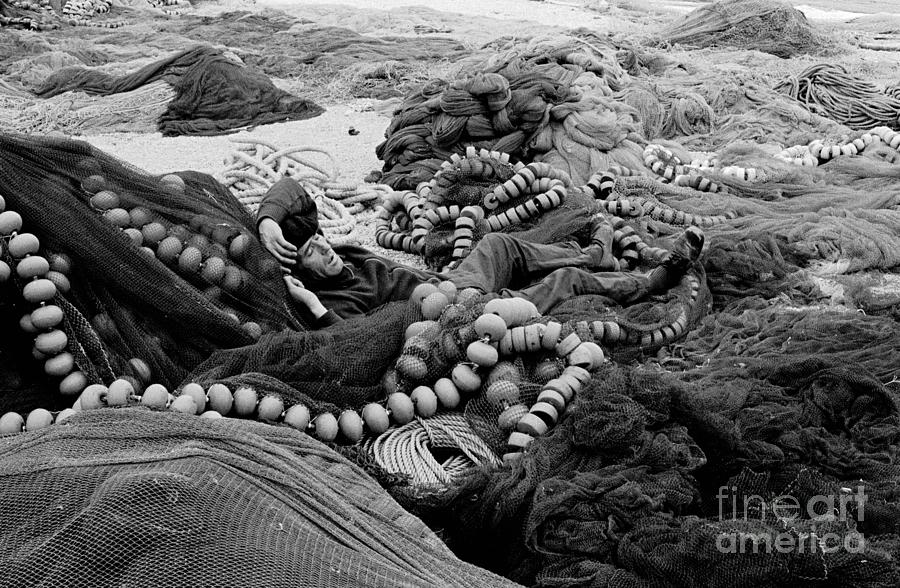 Fisherman Sleeping on a Huge Array of Nets Photograph by Tom Wurl