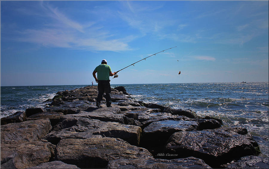 Fishing off of the Jetty Photograph by Mikki Cucuzzo