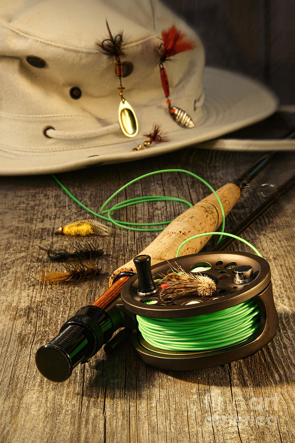 Fishing reel and hat on bench Photograph by Sandra Cunningham