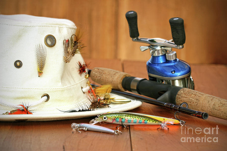 Fishing reel with hat and color lures by Sandra Cunningham