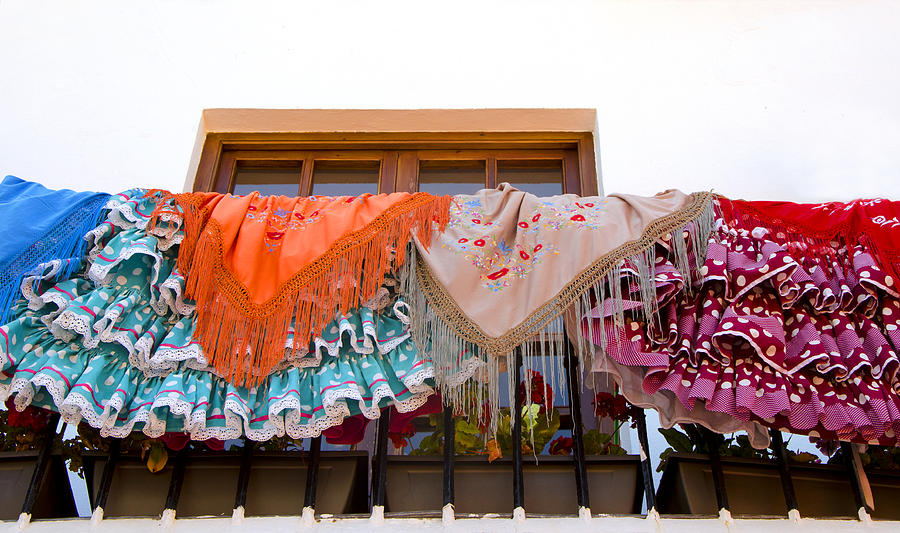 Flamenco dresses draped over balcony Photograph by Perry Van Munster