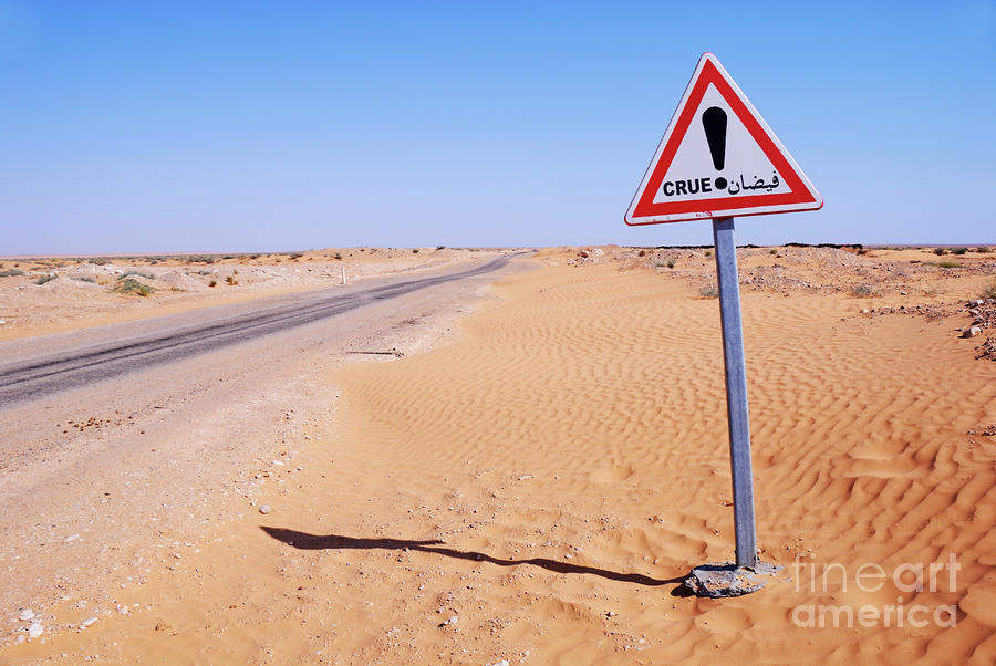 Flood warning sign on desert road Photograph by Sami Sarkis