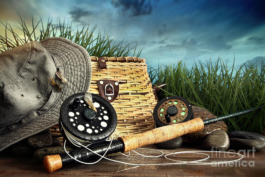 Fly fishing equipment with hat on wooden dock Photograph by Sandra