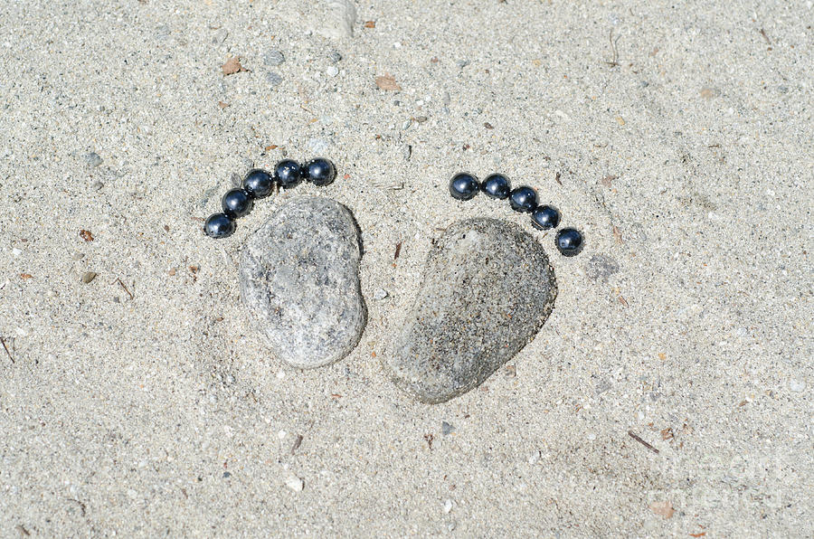 Beach Photograph - Footprints made of stones in the sand by Mats Silvan