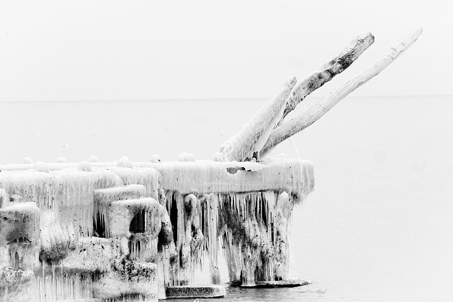 Frozen pier at Lake Erie Photograph by Emanuel Tanjala