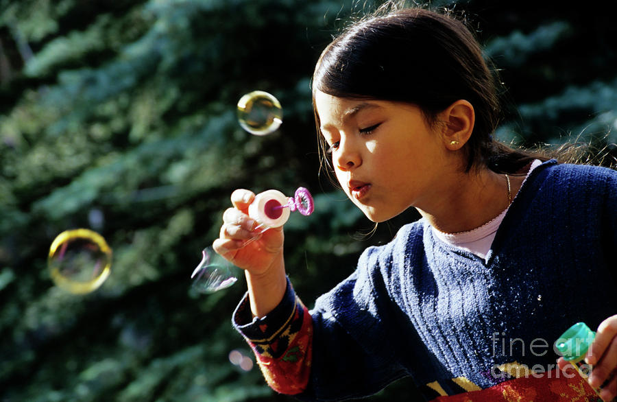 Girl blowing bubble-wand Photograph by Sami Sarkis