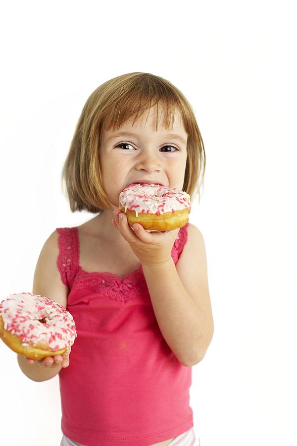 Donut Photograph - Girl Eating Doughnuts by Ian Boddy