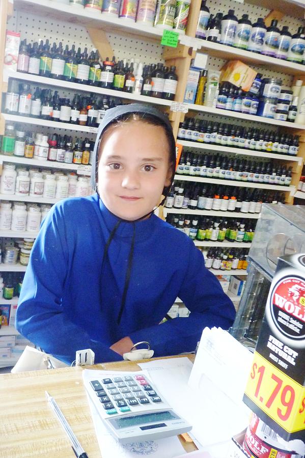 Girl in Amish Store Photograph by Jeanette Oberholtzer