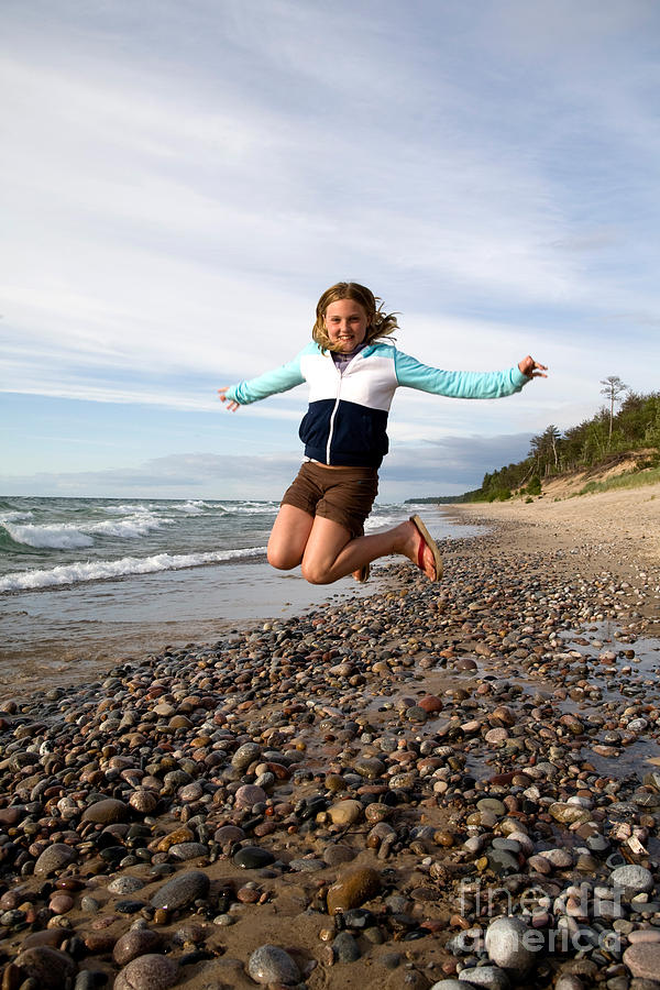 Girl Jumping At Lake Superior Shore Photograph by Ted Kinsman Girl Jumping At Lake Superior Shore Photograph by Ted Kinsman