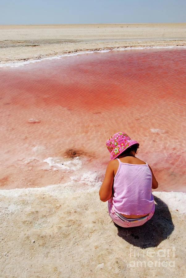 Nature Photograph - Girl looking at reddish dry salt lake by Sami Sarkis