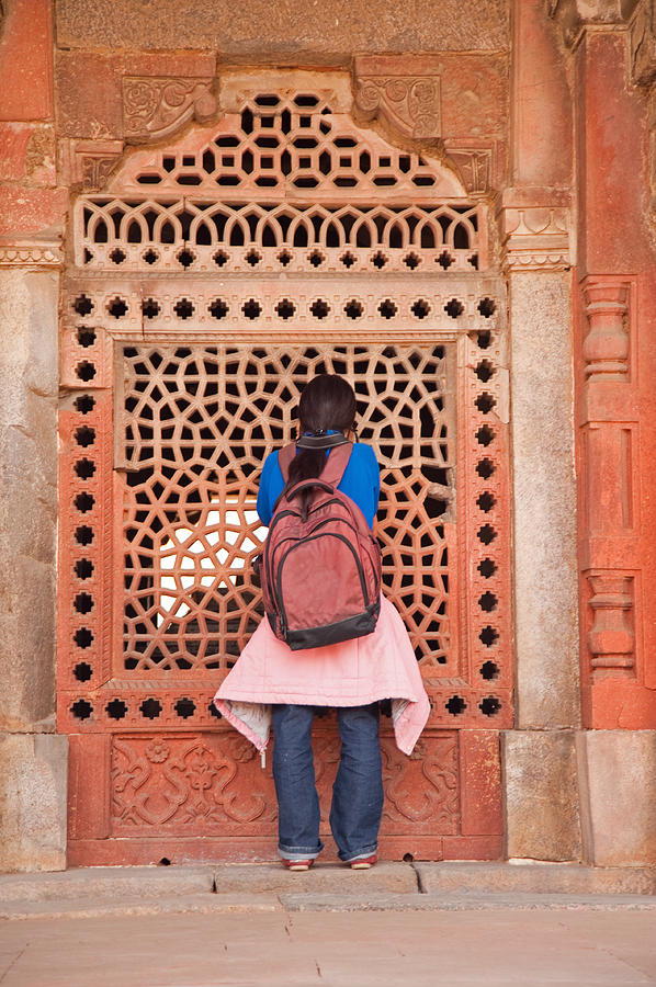Girl peering into the latticed wall at Humayun Tomb Photograph by Ashish Agarwal