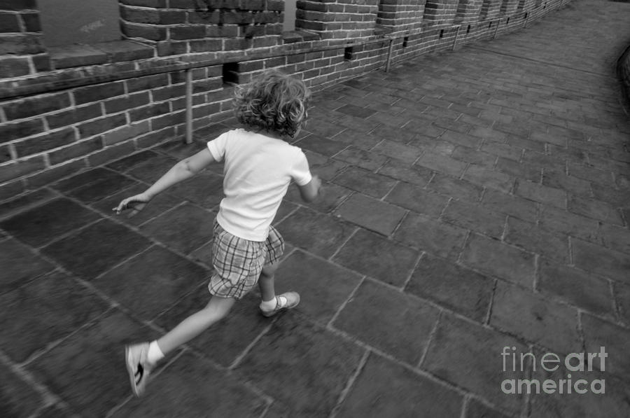 Girl running away on Great Wall of China Photograph by Sami Sarkis