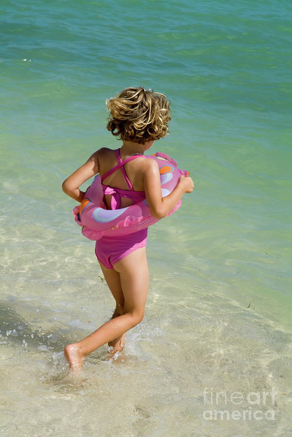 Beach Photograph - Girl running into water on beach by Sami Sarkis