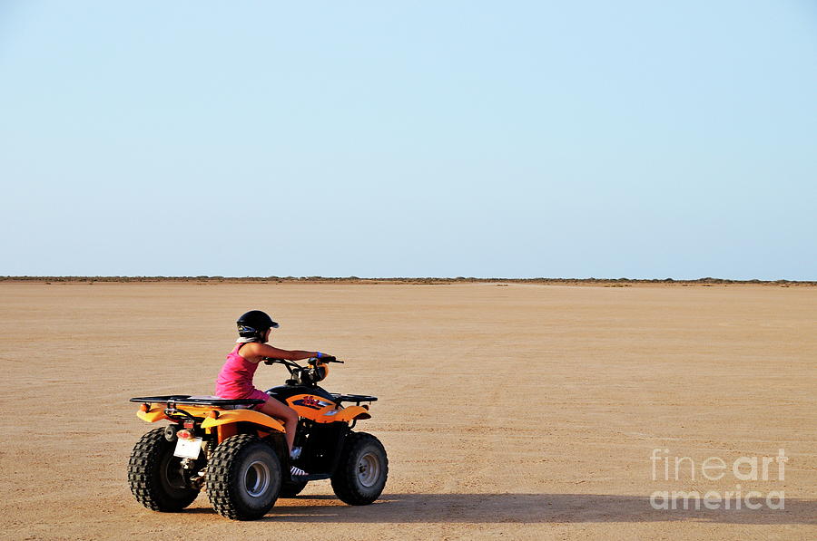 Girl speeding on ATV in desert Photograph by Sami Sarkis