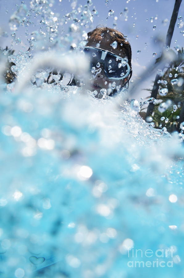 Girl splashing water in swimming pool Photograph by Sami Sarkis